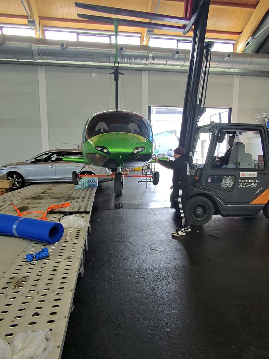 Green ARGON GTL gyroplane guided by hand onto the hall floor at AERO Friedrichshafen