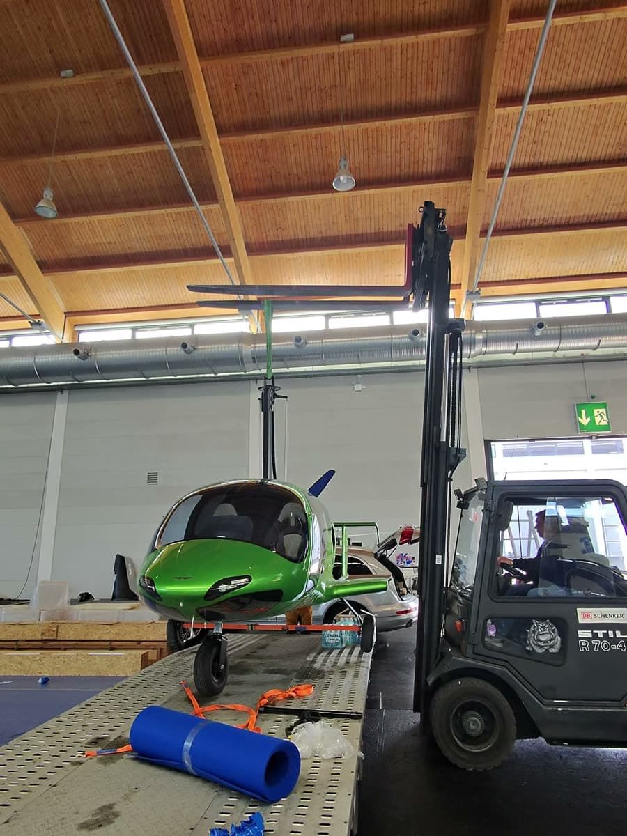 Metallic green ARGON GTL gyroplane lifted from the trailer at AERO Friedrichshafen