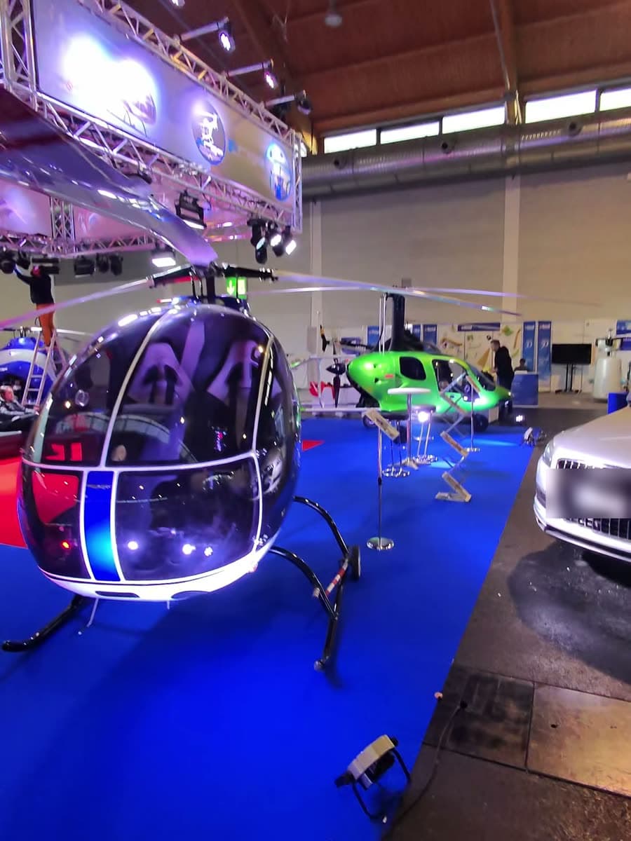 ARGO AH helicopter with LED underglow on the lit stand at AERO Friedrichshafen